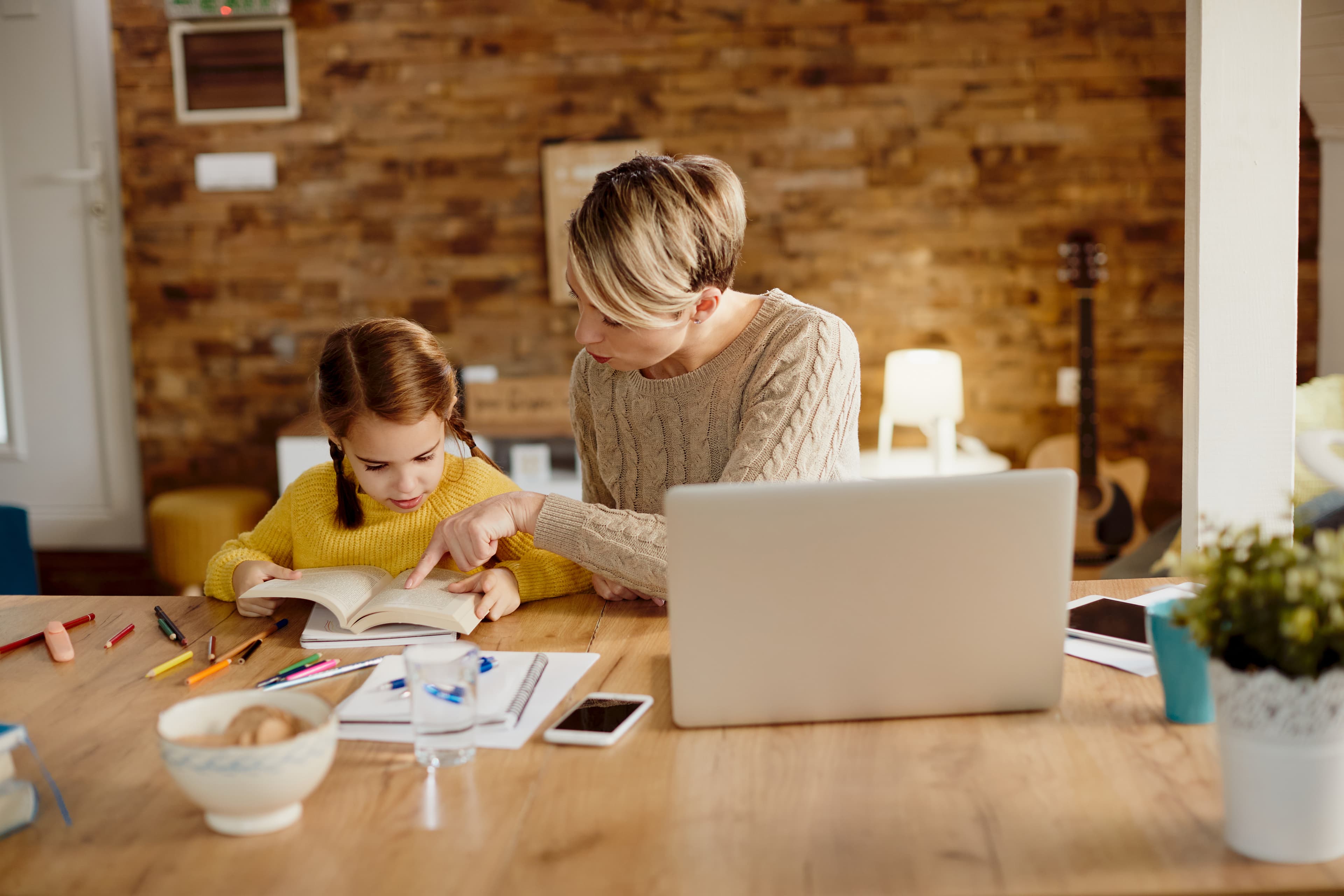 Mother homeschooling her daughter